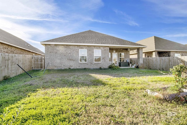 rear view of property featuring a yard