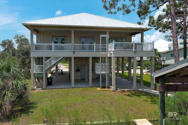 rear view of property with a yard and a patio area