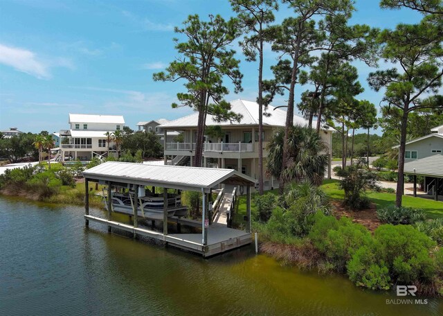 dock area with a balcony and a water view