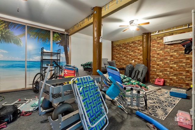 interior space with ceiling fan, brick wall, a water view, and a wall unit AC