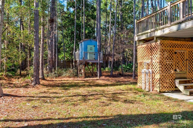 view of yard with a storage shed and a deck