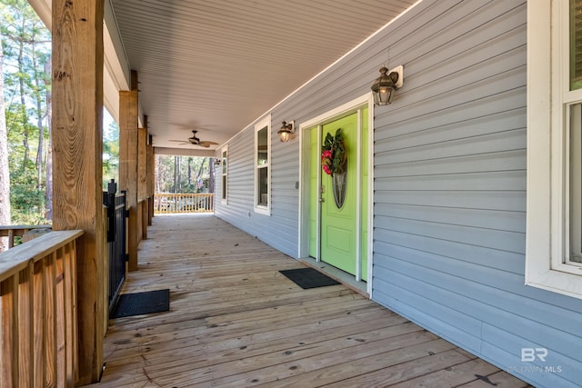 wooden deck featuring ceiling fan and covered porch