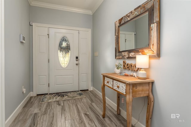 foyer entrance with light hardwood / wood-style floors and ornamental molding