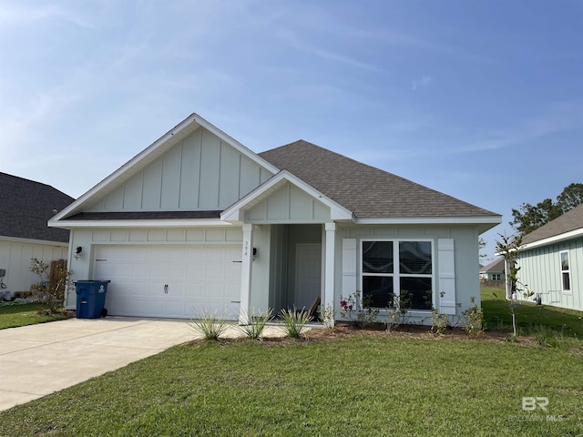 394 Haise Ln, Gulf Shores, AL 36542 - view of front of house with roof with shingles, board and batten siding, a front yard, driveway, and a garage