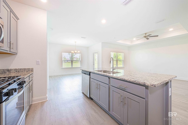 394 Haise Ln, Gulf Shores, AL 36542 - kitchen featuring gray cabinetry, stainless steel appliances, a sink, light wood-type flooring, and recessed lighting