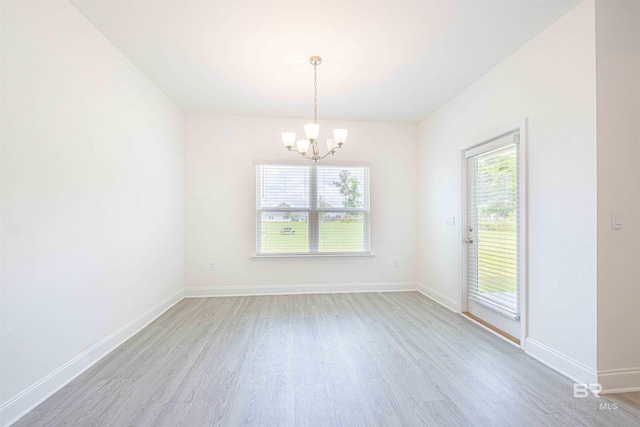 394 Haise Ln, Gulf Shores, AL 36542 - empty room with light wood-style flooring, a chandelier, and baseboards