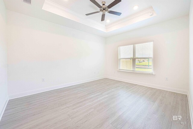 394 Haise Ln, Gulf Shores, AL 36542 - unfurnished room featuring a raised ceiling, ornamental molding, wood finished floors, baseboards, and recessed lighting