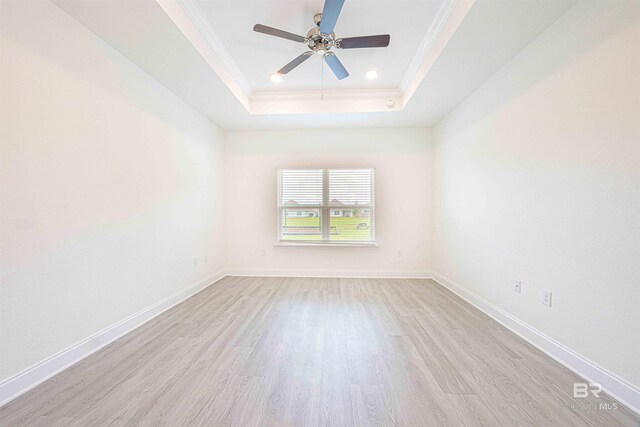 394 Haise Ln, Gulf Shores, AL 36542 - spare room with light wood finished floors, a raised ceiling, ornamental molding, baseboards, and recessed lighting
