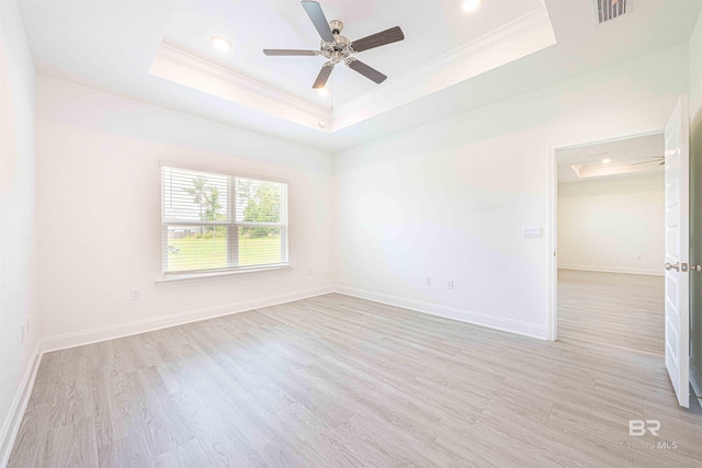 394 Haise Ln, Gulf Shores, AL 36542 - empty room featuring a tray ceiling, crown molding, light wood-style floors, ceiling fan, and baseboards