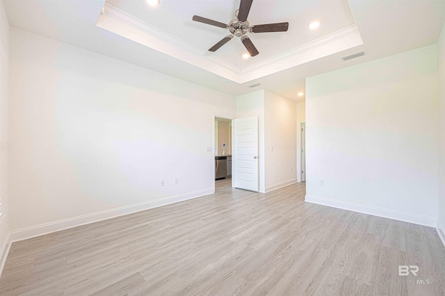 394 Haise Ln, Gulf Shores, AL 36542 - unfurnished room featuring a raised ceiling, ornamental molding, ceiling fan, light wood finished floors, and recessed lighting