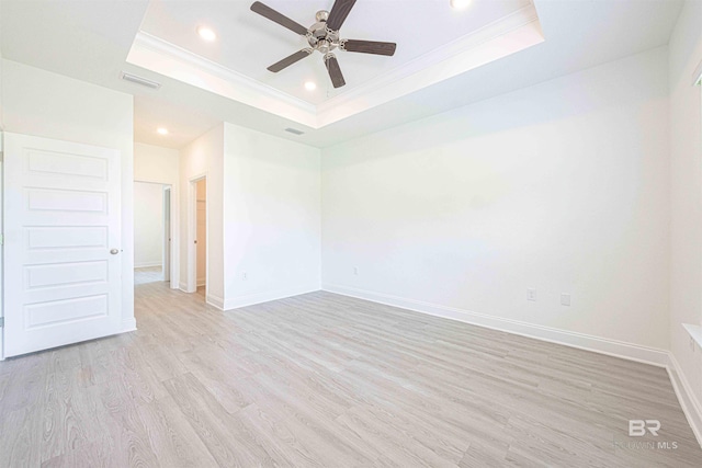 394 Haise Ln, Gulf Shores, AL 36542 - spare room featuring a raised ceiling, ornamental molding, ceiling fan, recessed lighting, and light wood finished floors