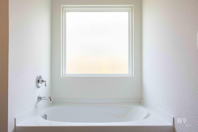 394 Haise Ln, Gulf Shores, AL 36542 - full bathroom with plenty of natural light, a textured wall, and a garden tub