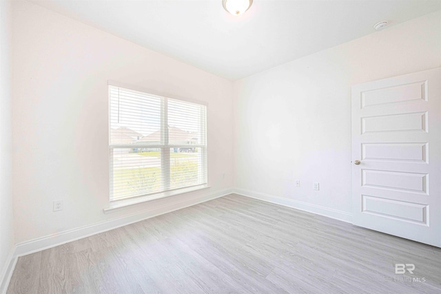 394 Haise Ln, Gulf Shores, AL 36542 - empty room with wood finished floors, baseboards, and a smoke detector