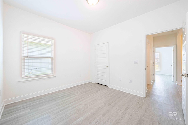 394 Haise Ln, Gulf Shores, AL 36542 - spare room featuring light wood-style floors, plenty of natural light, and baseboards