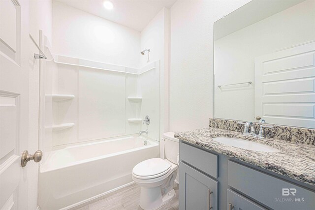 394 Haise Ln, Gulf Shores, AL 36542 - full bathroom featuring toilet, vanity, bathing tub / shower combination, and wood finished floors