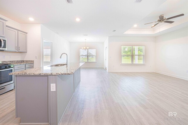 394 Haise Ln, Gulf Shores, AL 36542 - kitchen with gray cabinets, appliances with stainless steel finishes, plenty of natural light, light wood-type flooring, and recessed lighting