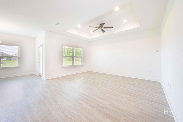 394 Haise Ln, Gulf Shores, AL 36542 - spare room featuring light wood-style floors, a ceiling fan, baseboards, a tray ceiling, and recessed lighting