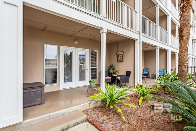 view of exterior entry with a patio