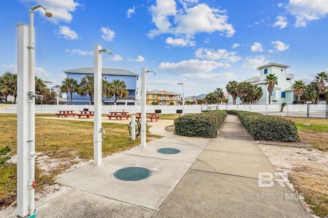 view of community with a lawn and a patio area