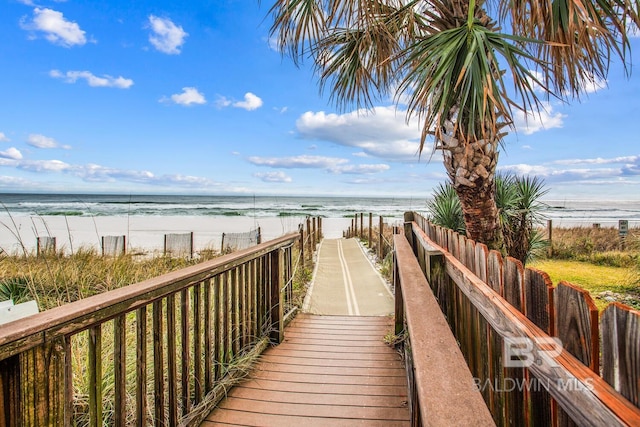 view of property's community featuring a water view and a view of the beach