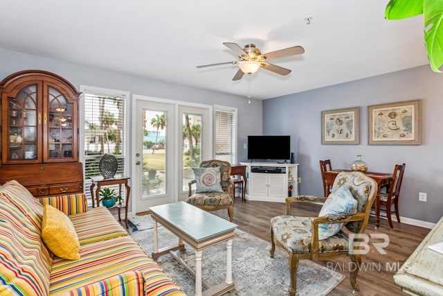 living room with ceiling fan and hardwood / wood-style floors