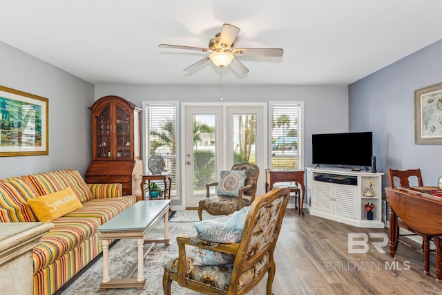 living room with ceiling fan and light hardwood / wood-style floors