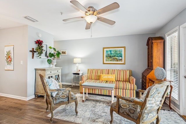 living area with ceiling fan and wood-type flooring