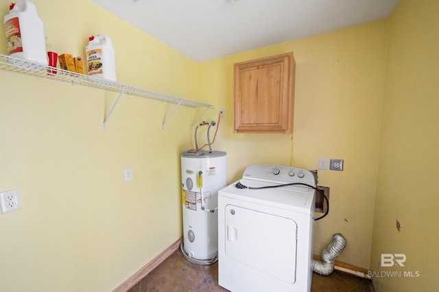 washroom featuring dark tile patterned flooring, washer / clothes dryer, water heater, baseboards, and laundry area
