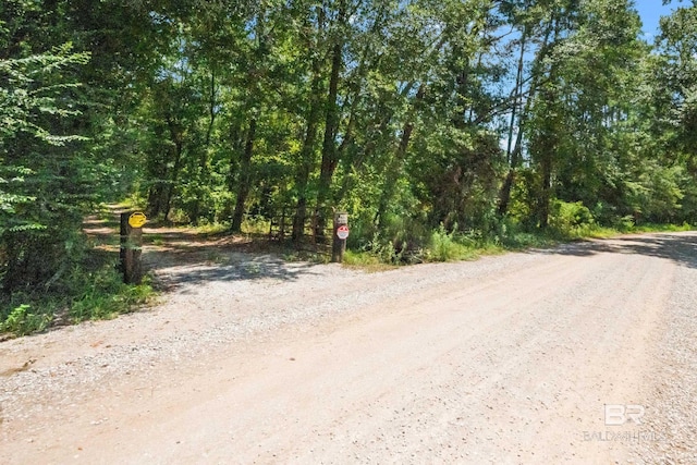 view of road featuring a wooded view