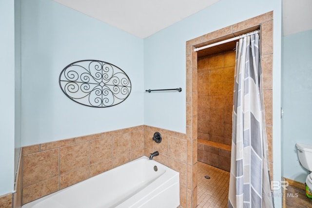 bathroom featuring toilet, a bath, and tiled shower