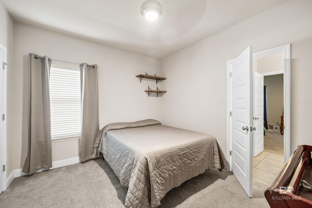 carpeted bedroom featuring baseboards