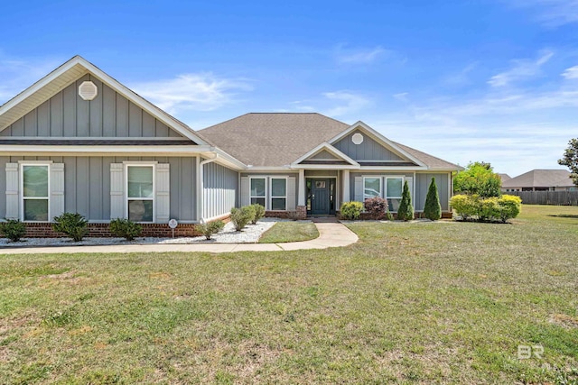 craftsman inspired home with board and batten siding, brick siding, roof with shingles, and a front lawn