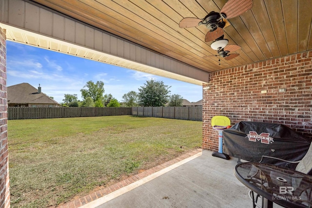 view of yard featuring a patio, ceiling fan, and a fenced backyard