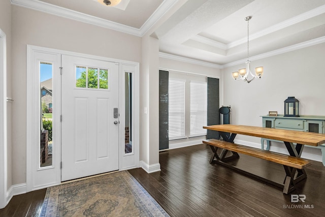 entryway featuring baseboards, ornamental molding, hardwood / wood-style floors, and an inviting chandelier
