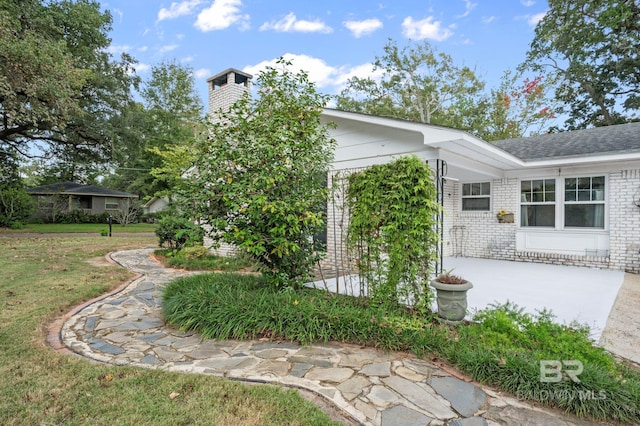 exterior space with a patio and a lawn