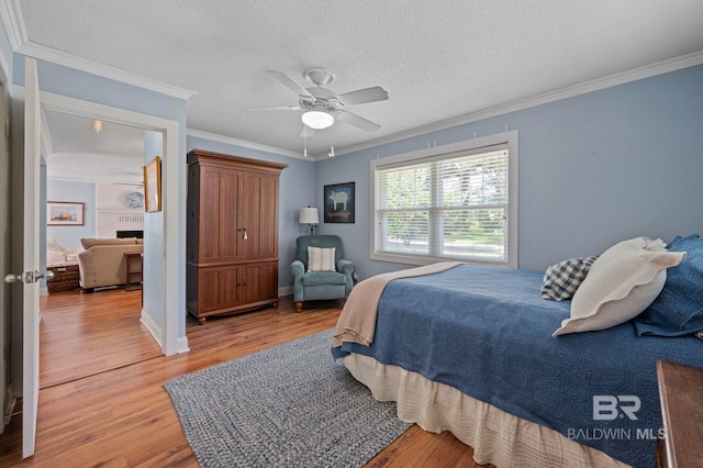 bedroom with ceiling fan, light hardwood / wood-style flooring, and ornamental molding