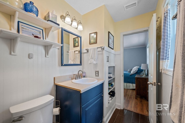 bathroom featuring hardwood / wood-style flooring, vanity, and toilet