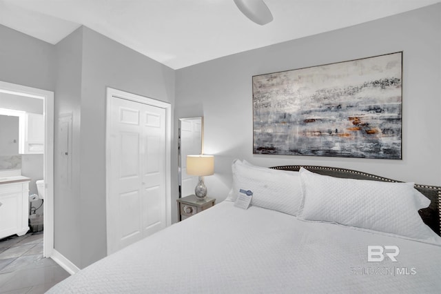 bedroom with connected bathroom, ceiling fan, and a closet