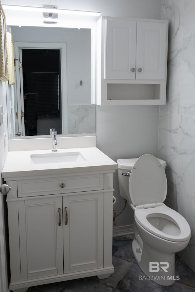 bathroom featuring toilet and vanity