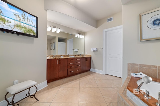 bathroom with tile patterned floors, visible vents, a garden tub, and double vanity