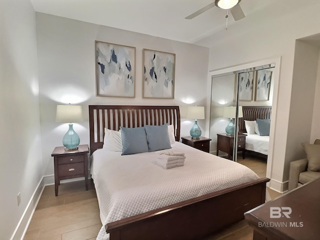 bedroom with a closet, ceiling fan, and baseboards