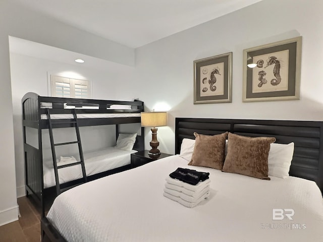 bedroom with dark wood-style floors and baseboards