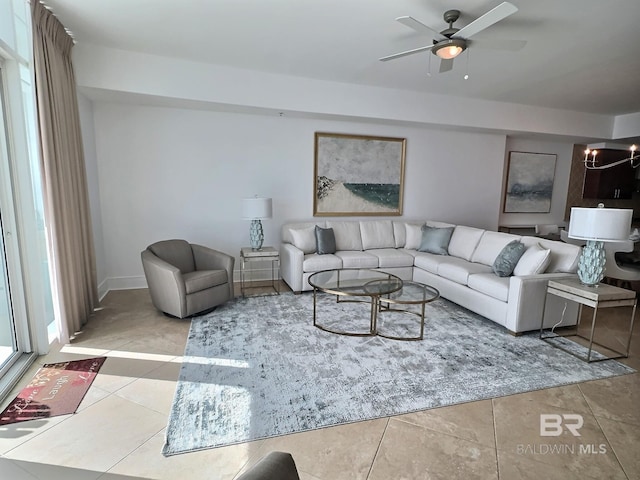 living room with ceiling fan with notable chandelier and tile patterned flooring