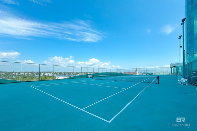 view of sport court featuring fence