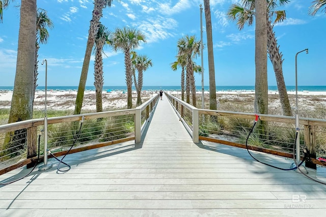 wooden terrace with a beach view and a water view