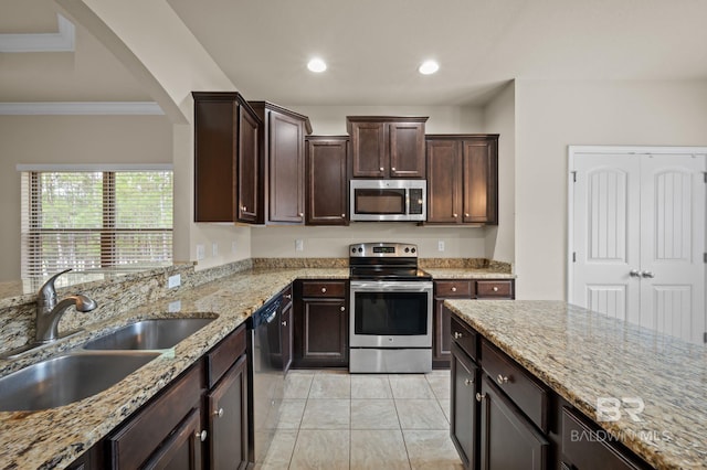 750 Cheswick Ave, Fairhope, AL 36532 - kitchen with appliances with stainless steel finishes, a sink, light stone counters, dark brown cabinetry, and ornamental molding
