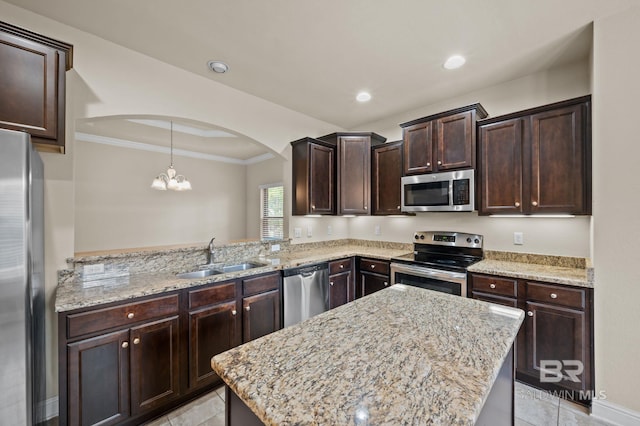 750 Cheswick Ave, Fairhope, AL 36532 - kitchen with appliances with stainless steel finishes, a sink, arched walkways, light tile patterned flooring, and ornamental molding