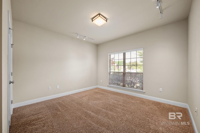 750 Cheswick Ave, Fairhope, AL 36532 - spare room featuring rail lighting, carpet floors, and baseboards