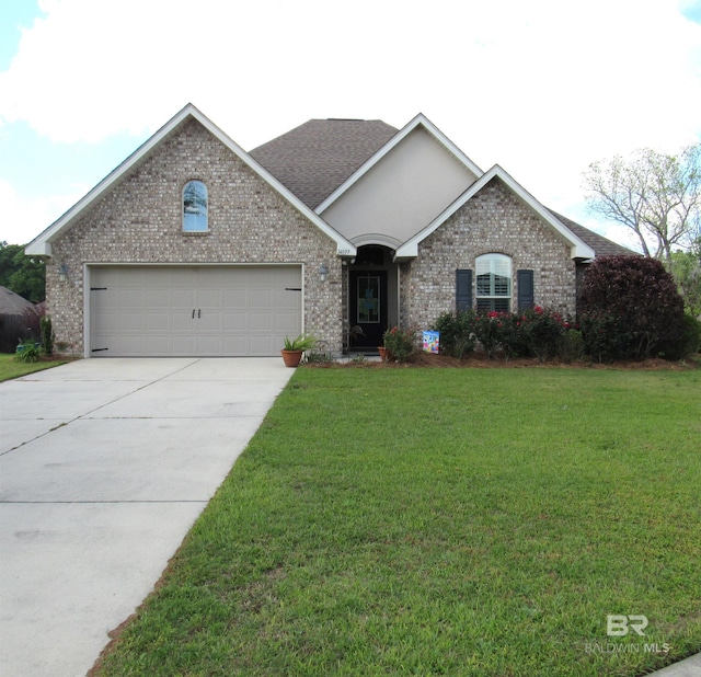 single story home with a garage, a front yard, brick siding, and driveway