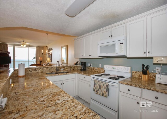 527 Beach Club Trl Unit C1006, Gulf Shores, AL 36542 - kitchen with a sink, white cabinets, and white appliances